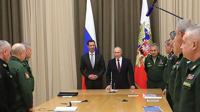 Assad and Putin, surrounded by top Russian security officials 