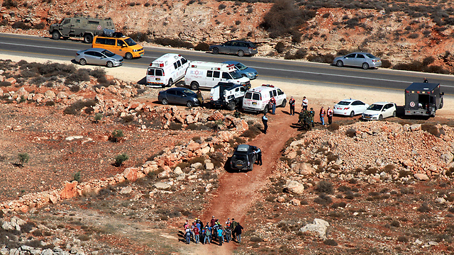 Emergency services outside Qusra (Photo: EPA)