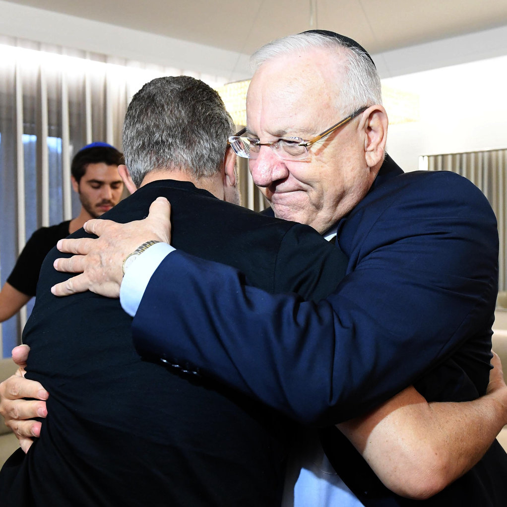 President Rivlin embraces Boaz Kokia, the soldier's father (Photo: Mark Neiman/GPO)