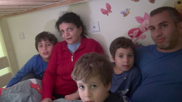 Tal Bornstein, with his mother and three children, spending the night in a security room (Photo: Barel Efraim)