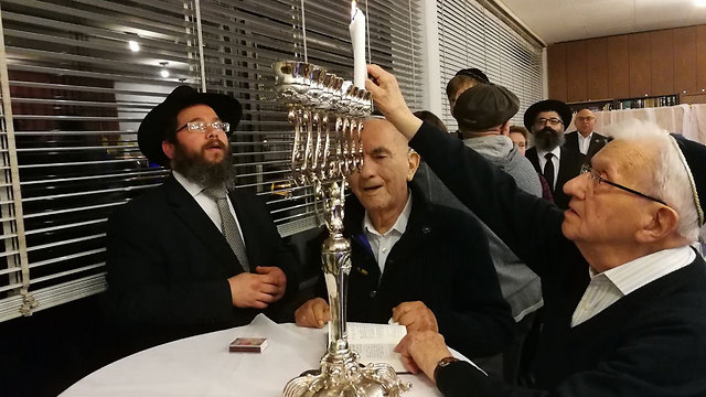 File photo: Holocaust survivors lighting Hanukkiah. Katz said he'd have no choice but to close Holocaust survivors' centers (Photo: German Rabbis' Association)