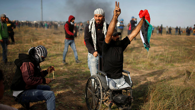 Abu Thuraya during a protest near the border fence (Photo: Reuters)