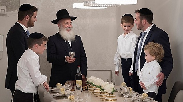 A Haredi family's Shabbat table--with no women present (Photo: Lapam)