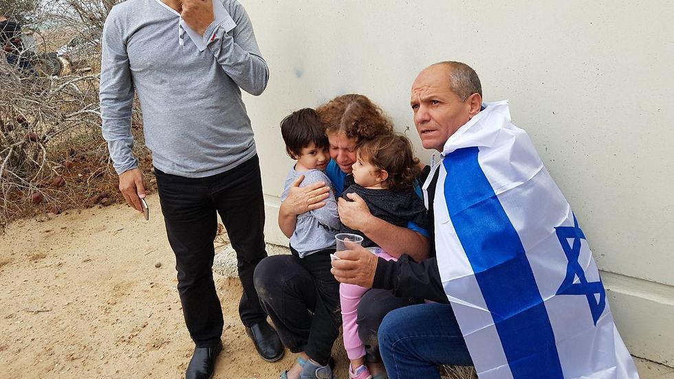 Families take cover during rocket fire on Friday (Photo: Roee Idan)