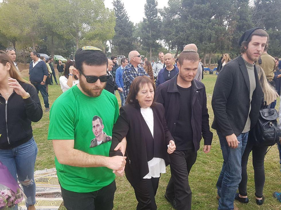 The slain soldier's mother being led to a shelter (Photo: Matan Tzuri)