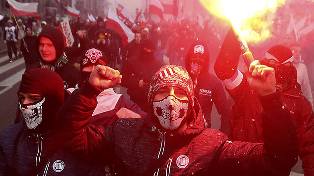 Far-right nationalists burn flares in Warsaw on Poland’s Independence Day (Photo: AP)