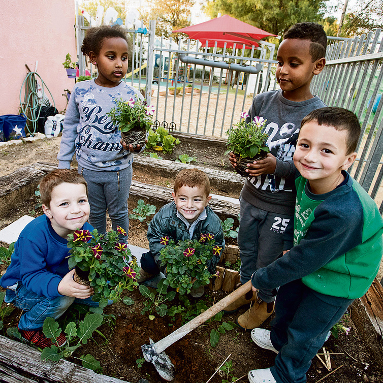 Children planting in the Weizmann School's ecological garden in Kiryat Motzkin (Photo: Gil Nechushtan)