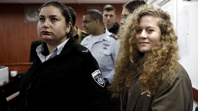 Ahed Tamimi (R) was sentenced to 5 months in prison for slapping an IDF officer (Photo: AFP)