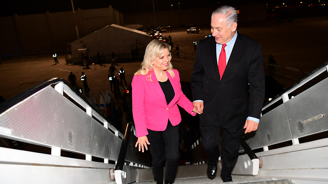 PM Netanyahu (R) and his wife Sara departing for Munich (Photo: Amos Ben Gershom/GPO)