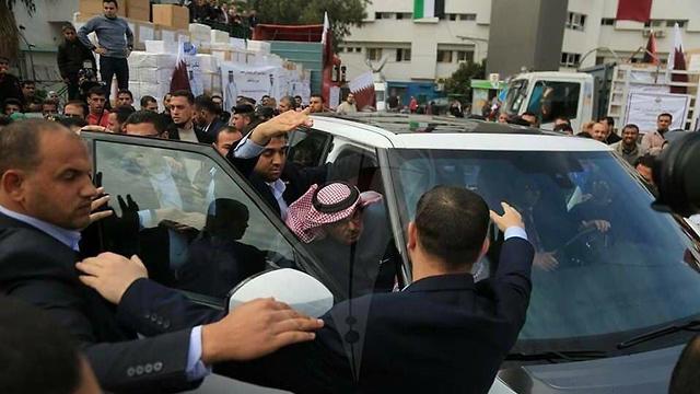 Al-Emadi exits his vehicle among angry Gazans