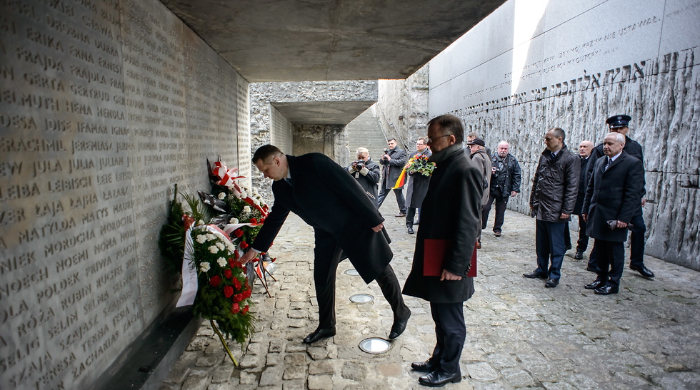 Sellin, center, and and the province governor of Lublin Przemysaw Czarnek, left, lay flowers at a memorial site on the second day of ceremonies held to mark the 75th anniversary of the first mass deportations of Jews to the Nazi German death camp in Belzec and the beginning of the Operation Reinhardt.