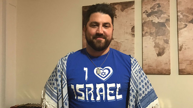 Ryan Ali Yazdi wears an 'I love Israel' t-shirt and a necklace with a pendant containing Koranic verses