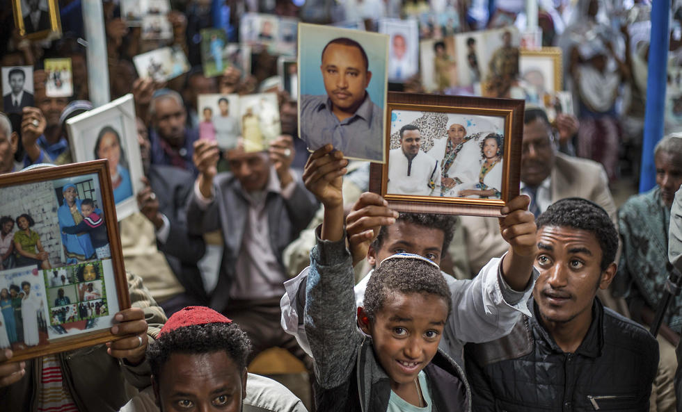 Members of Ethiopia's Jewish community hold pictures of their relatives in Israel, during a solidarity event at the synagogue in Addis Ababa (Photo: AP)