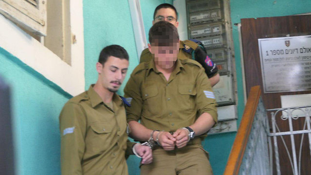 The soldier being led into military court (Photo: Zvika Tishler)