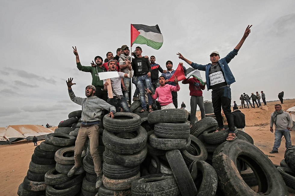 Palestinians gathering tires to burn in Friday's demonstrations (Photo: AFP)