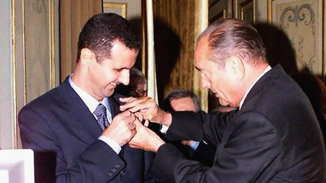 French President Chirac awards Assad the Légion d'honneur, (Photo: MCT)