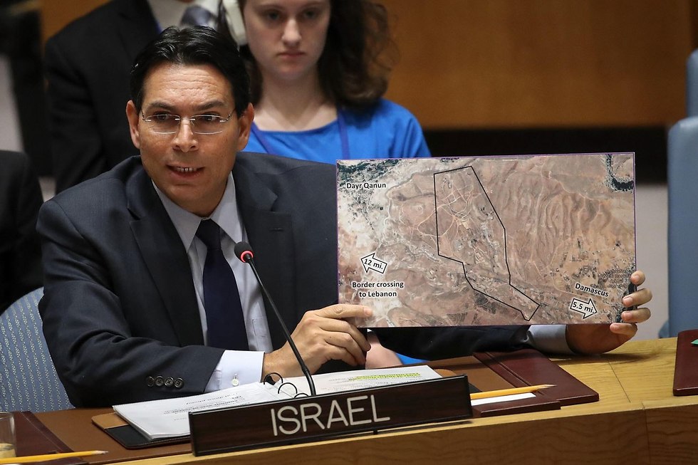 Israel's ambassador to the United Nations Danny Danon holding up an aerial picture of the Iranian base (Photo: AFP)