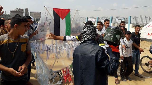 Protesters preparing kite to send burning across the border
