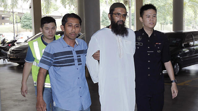 Danish national Sulaiman (2nd left) was convicted of spreading fake news after criticizing Malaysian police's handling of the assassination (Photo: AP)