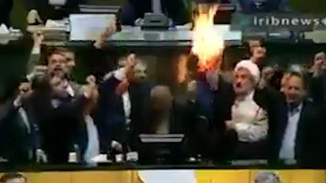 Setting fire to the US flag at the Iranian parliament