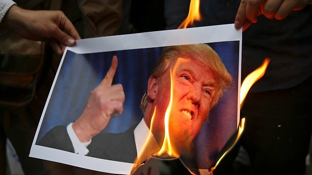 Trump image being burned in Iran (Photo: AP)