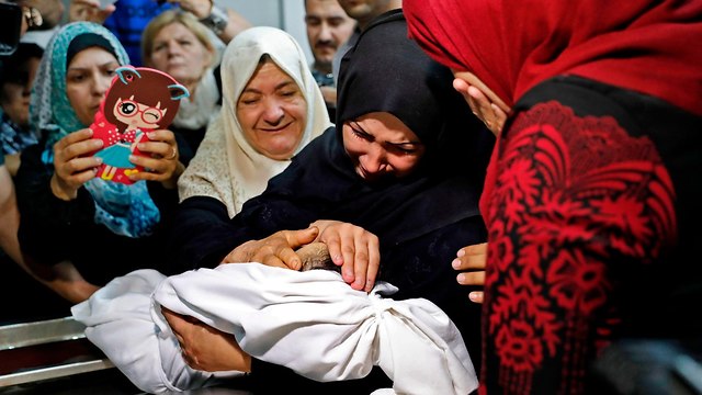 Family mourning eight-month-old Leila al-Ghandour, who allegedly suffocated by teargas  (Photo: AFP)