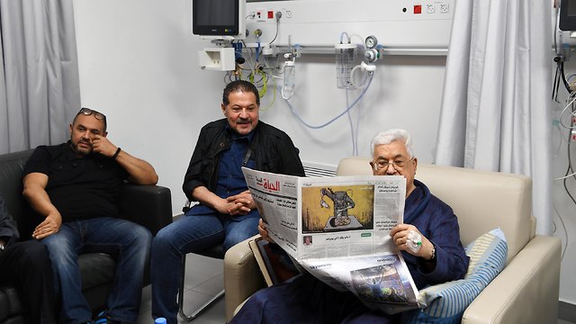 Abbas with sons Yasser and Tareq at the hospital in Ramallah in May (Photo: Reuters)