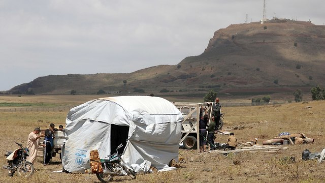 Syrian refugees near an IDF post in the Golan Heights (Photo: Reuters)