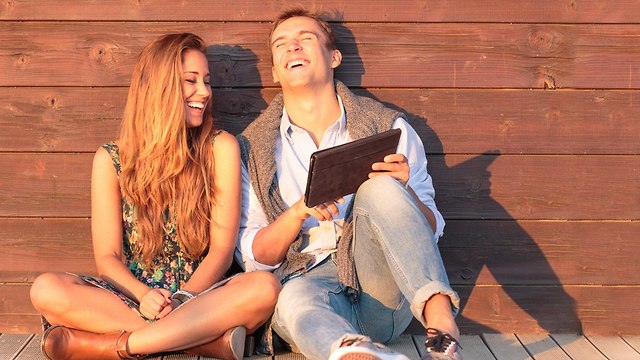 זוג צעיר מתפקע מצחוק (צילום: Shutterstock)