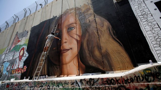 Mural of Ahed Tamimi painted on West Bank wall (Photo: Reuters)