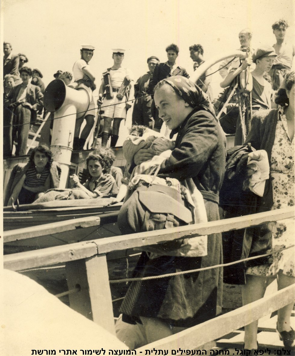 מעפילה ותינוק יורדים מהאוניה (צילום: ליפא קוגל)