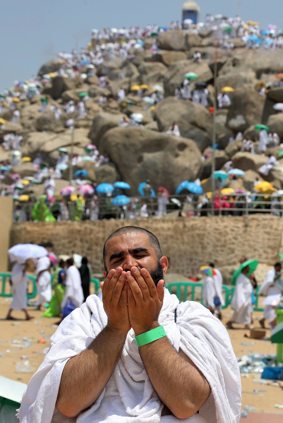 A Muslim prays, Mt. Arafat in background
