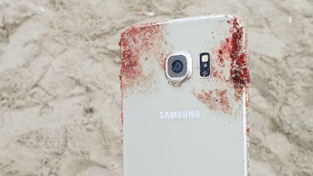 Phone of one of victims covered with blood 