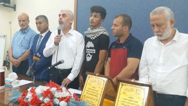 Hamas ceremony awarding Palestinian rioters certificates of appreciation. 