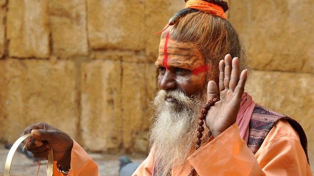 אדם שפניו צבועות במהלך טקס בהודו (צילום: באדיבות החברה הגיאוגרפית)