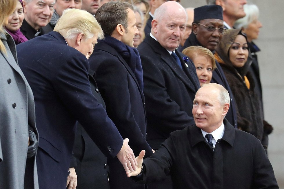 Donald Trump greets Vladimir Putin during the commemorations to mark 100 years since the end of World War II, in Paris in November 2018 
