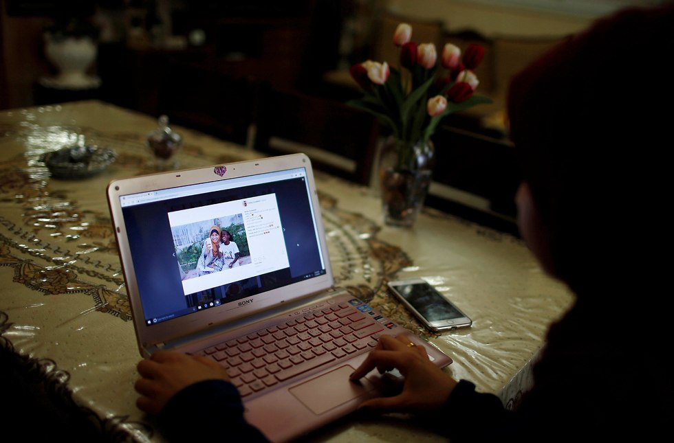Fatma Abu Musabbeh views one of her Instagram posts on her laptop in her family house in the central Gaza Strip (Photo: Reuters)