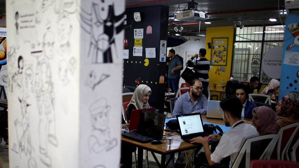 Members of 'We Are Not Numbers' team work on laptops in an office in Gaza City (Photo: Reuters)