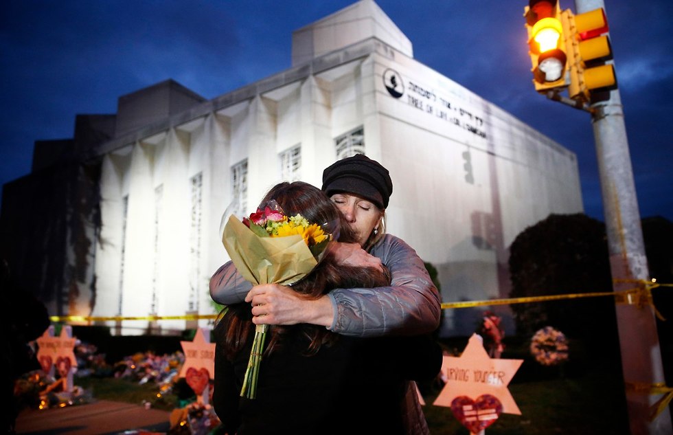 Mourners embrace at the scene of a brutal attack at a Pittsburgh synagogue that claimed 11 lives in  (Photo: EPA)