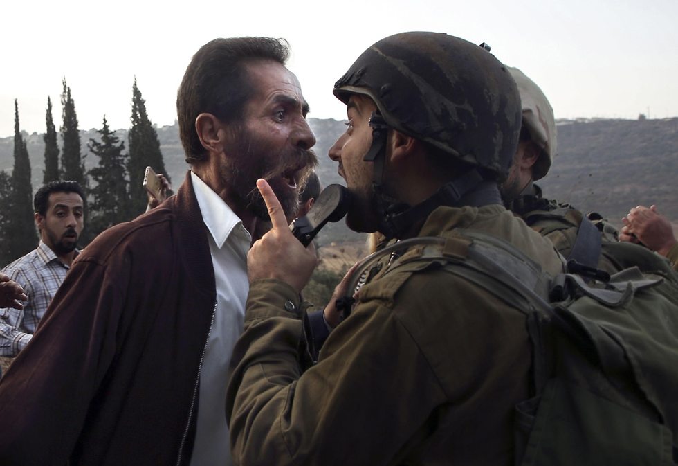 IDF soldier and a Palestinian protester clash over the closure of a school in As-Sawiya near Nablus.  (Photo: AFP)