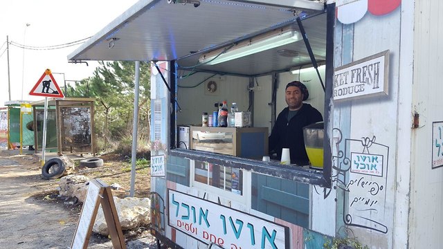 Raz Chen, who owns a kiosk located near Giv'at Asaf