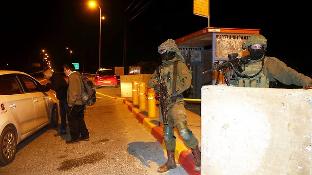 IDF soldiers securing hitchhiking stop in the West Bank