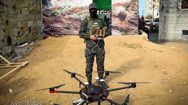 Illustrative: A Hamas fighter stands with a drone in Gaza