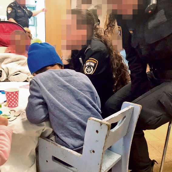 Police officers celebrate Hanukkah with the children at the shelter