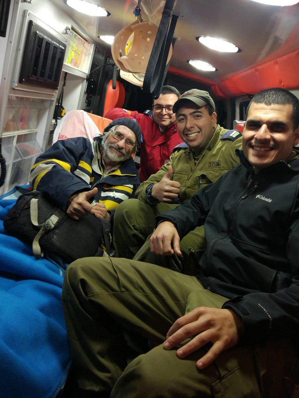 The French sailor being evacuated to the hospital, with the sailors who saved him (Photo: IDF Spokesperson's Unit  )