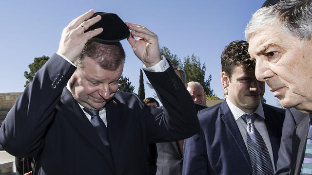 Lithuania's Prime Minister Saulius Skvernelis puts on a kippa as he enters the Hall of Remembrance at the Yad Vashem Holocaust memorial in Jerusalem, Tuesday January 29, 2019