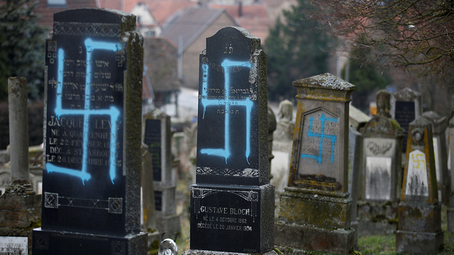 Graves desecrated with swastikas are seen in the Jewish cemetery in Quatzenheim, near Strasbourg, France, February 19, 2019 (Photo: Reuters)
