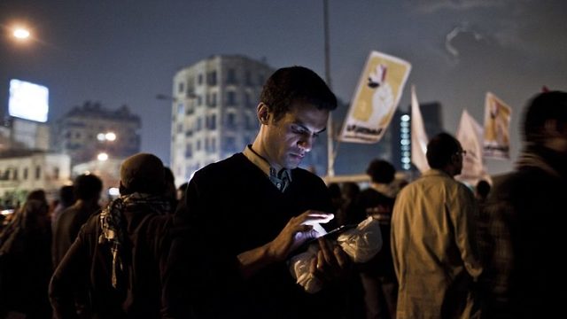 A protester uses his cell phone during a demonstration against former Egyptian president Mohammed Mursi in Cairo in 2012.