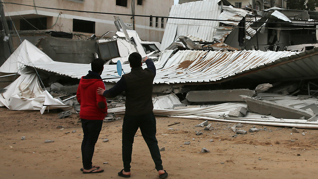 Palestinians inspect the damage from an IAF airstrike in Gaza (Photo: AP)