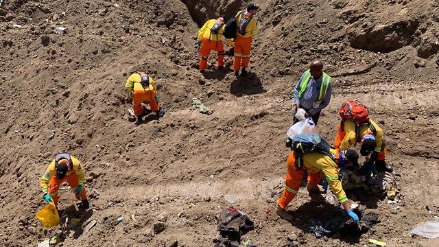 ZAKA volunteers searching for human remains at the site of the plane crash